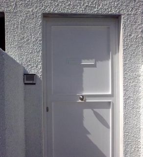 Puerta de hierro de una casa en color blanco